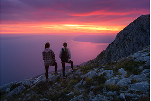 Two women hikers with backpacks, a Person Photo by den-belitsky