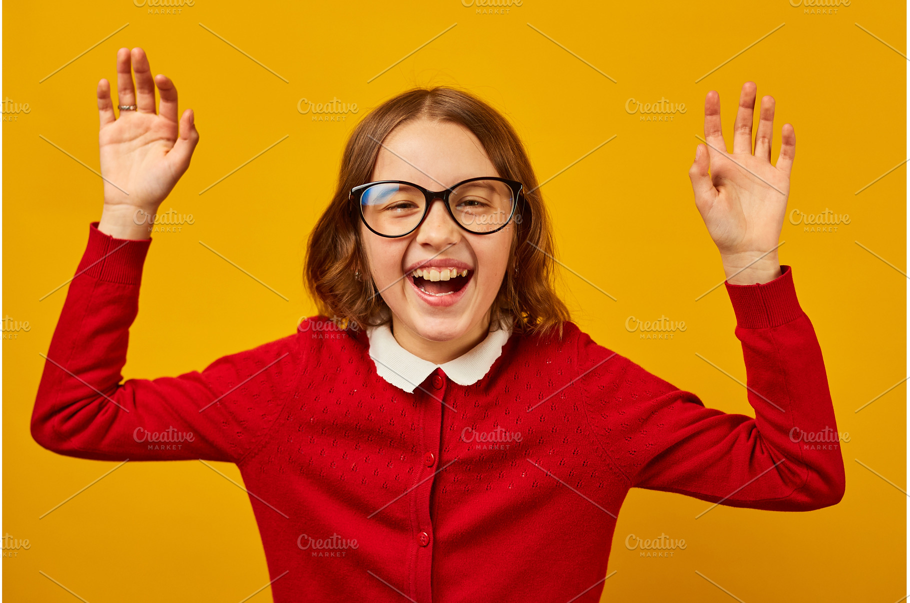 Girl wearing glasses celebrates, a School & Education Photo by IlliaBondarPhotography