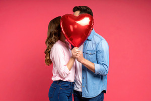 Romantic couple hiding behind heart balloon, a Holiday Photo by Davizro's Market