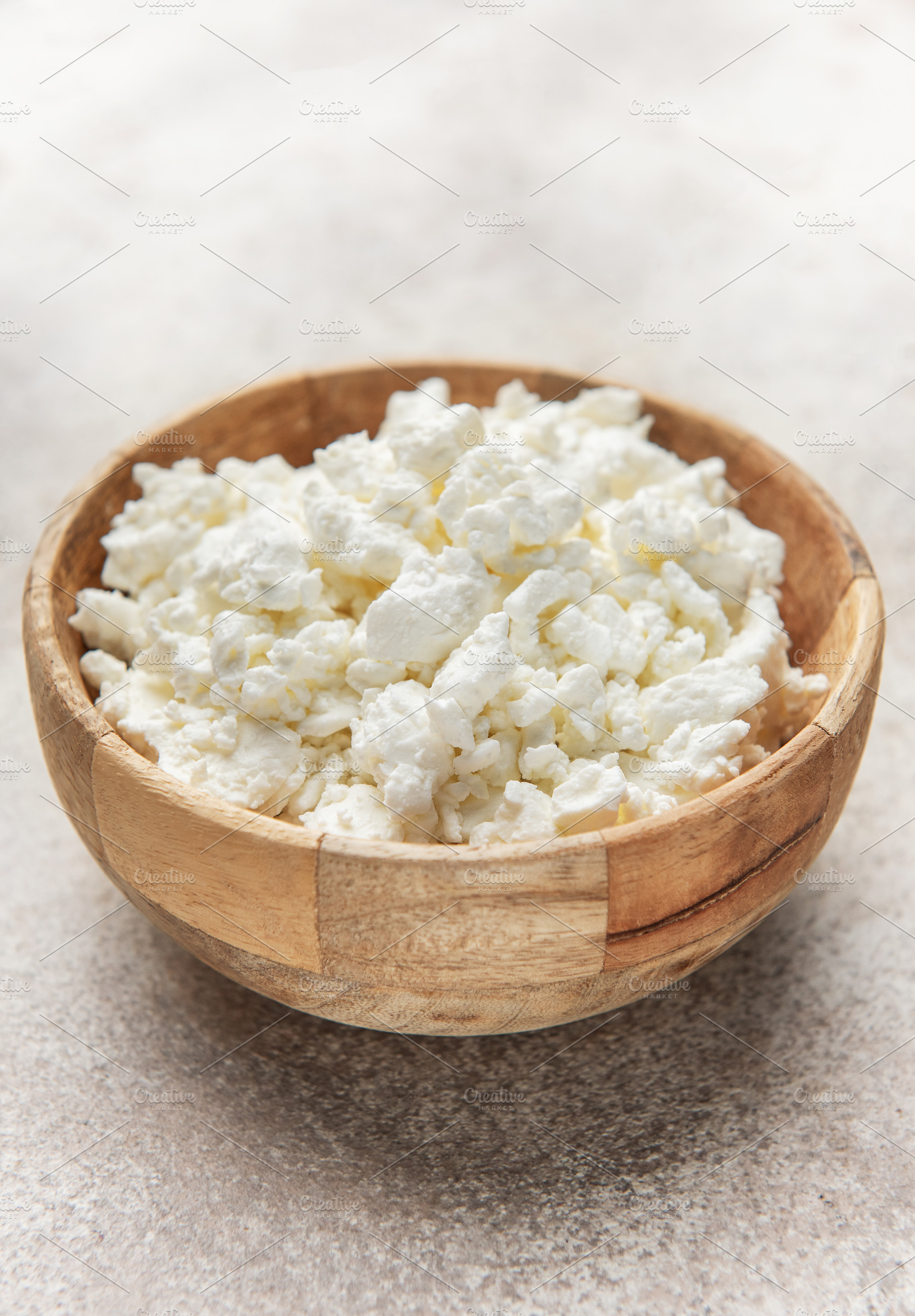 Cottage cheese in wooden bowl for healthy breakfast, a Food & Drink Photo by Olena Rudo