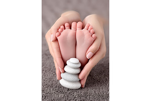 A newborn baby's feet resting on the, a Person Photo by ZinetroN