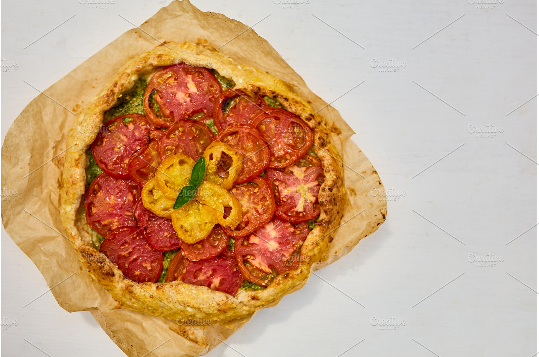 Freshly baked tomato galette on, a Food & Drink Photo by IlliaBondarPhotography