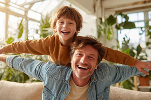 Happy father and son playing airplan, a Photo by Pixeness Studio