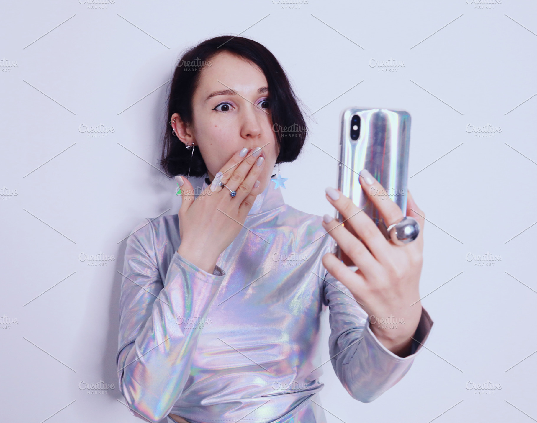Surprised girl looks at the iPhone, a Beauty & Fashion Photo by Natalia Flurno