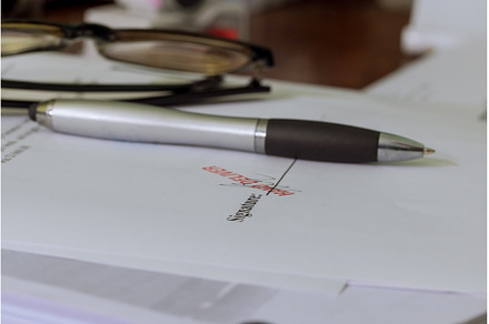 Close-up of with pen over document, a Business Photo by Ungvar Studio