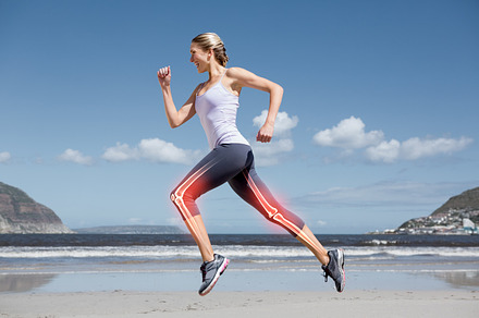 Highlighted leg bones of jogging woman on beach, a Photo by wavebreak