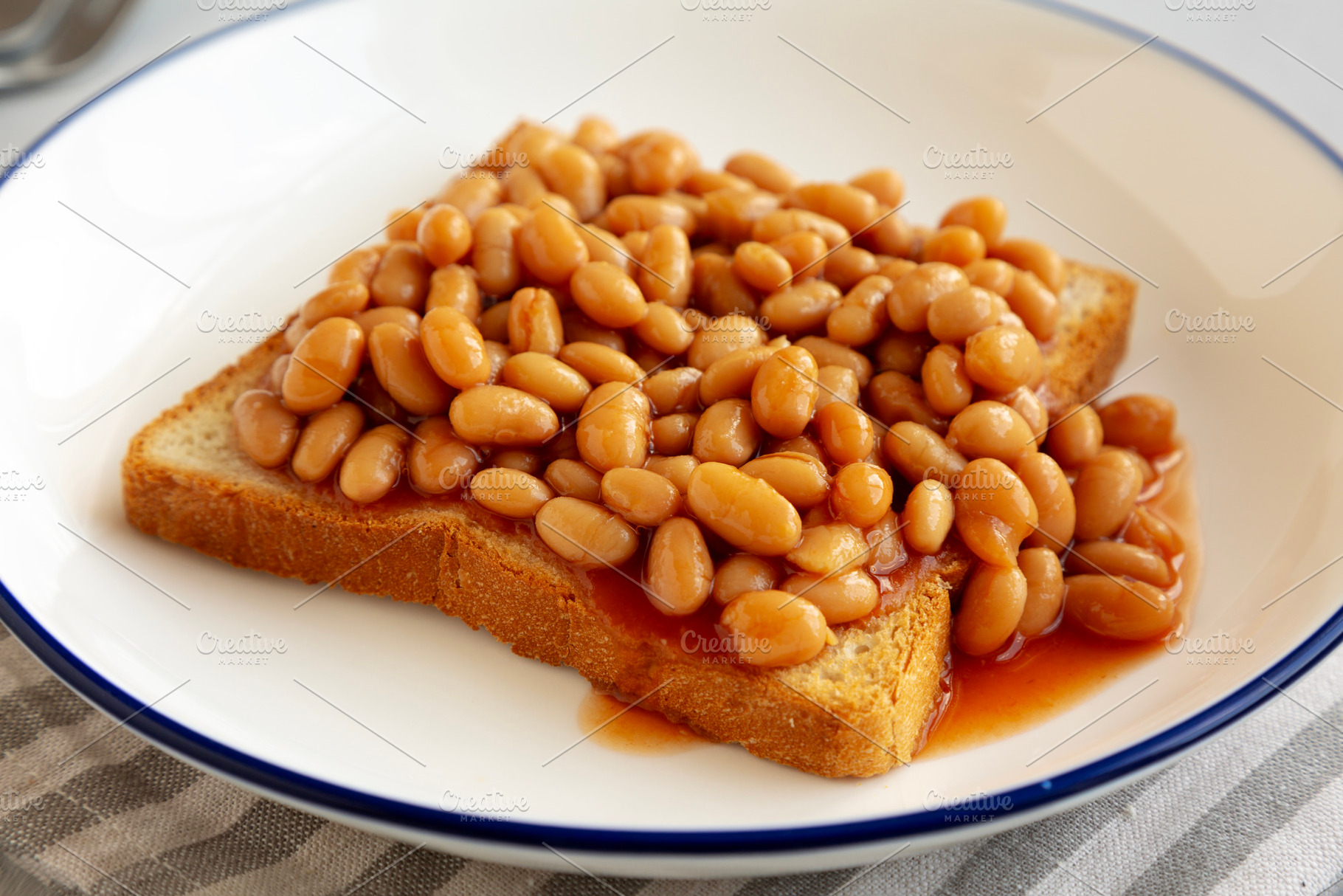 Homemade English Beans on Toast, low angle view. Close-up., a Food & Drink Photo by LiudmylaChuhunova