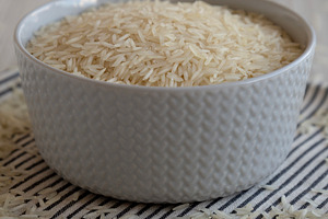 Uncooked White Organic Basmati Rice in a Bowl, side view. Close-, a Food & Drink Photo by LiudmylaChuhunova