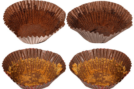 Empty brown paper cupcake or muffin tin with chocolate residue,