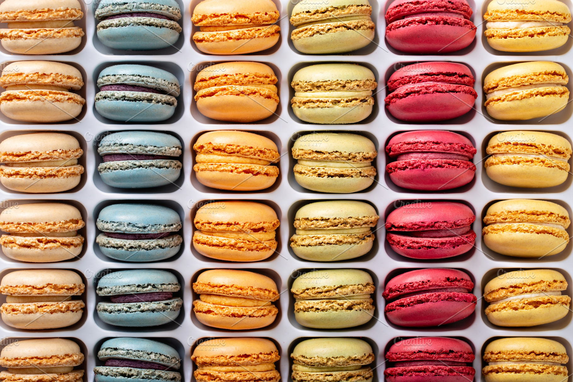 Colorful french macarons in a box, a Food & Drink Photo by farwasser