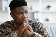 Unhappy military black man standing next to window, a Photo by Prostock-Studio (Thumbnail 4 of 7)