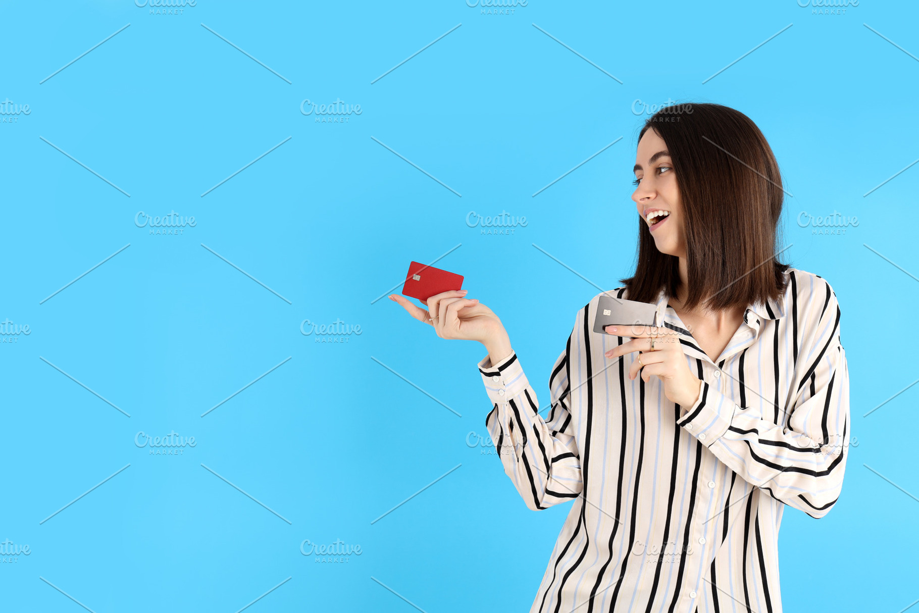 Attractive woman with cards on blue background, a Person Photo by AtlasStudio PRO