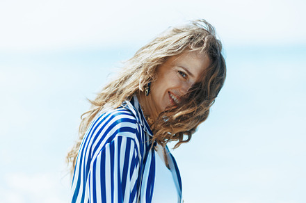 smiling modern female on seacoast having fun time, a Person Photo by Alliance Images
