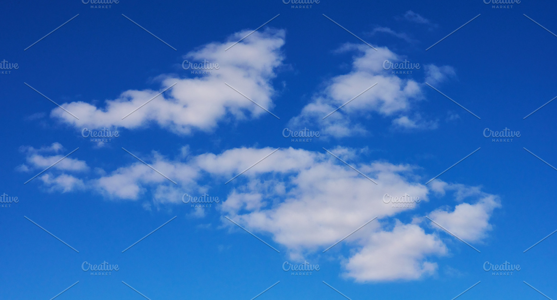 Several small cumulus clouds with soft white edges hovering agai, a Nature Photo by ndanko