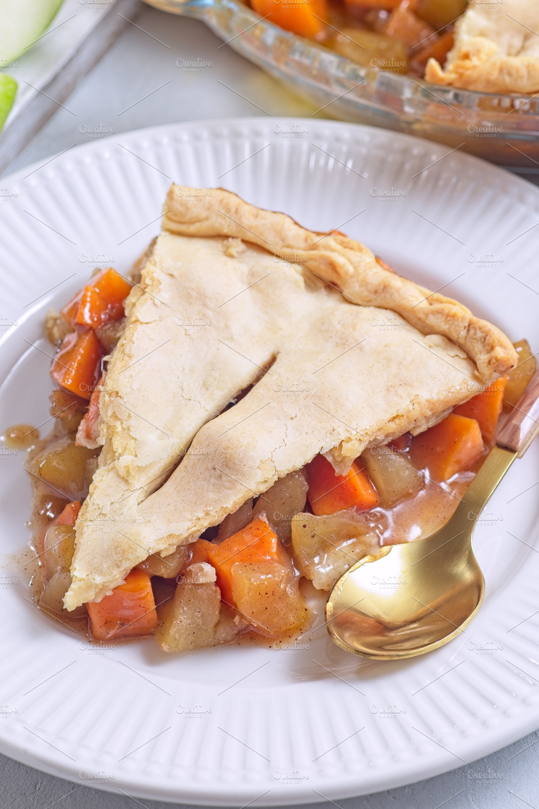 Homemade apple and sweet potato cobbler pie showing filling ingredients, vertic, a Food & Drink Photo by iuliia_n