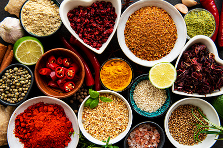 Various spices in a bowls on black concrete background. Top view, a Food & Drink Photo by Olena Rudo