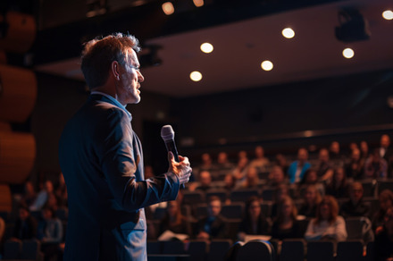 Speaker addressing audience at business conference, an Abstract Photo by Natalia Klenova's Shop