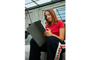 School girl uses tablet while, a School & Education Photo by IlliaBondarPhotography