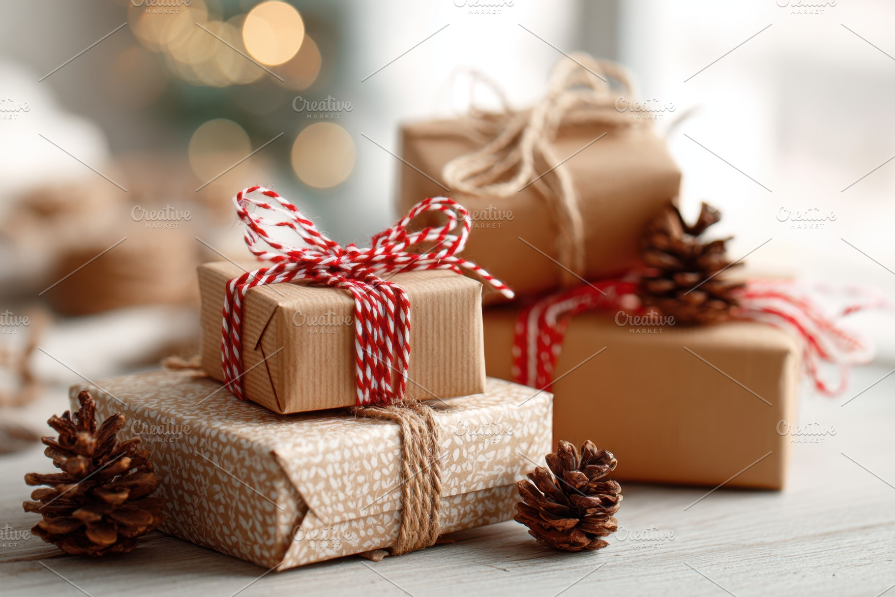 Beautifully wrapped holiday gifts with pine cones, a Holiday Photo by AlyaAnd