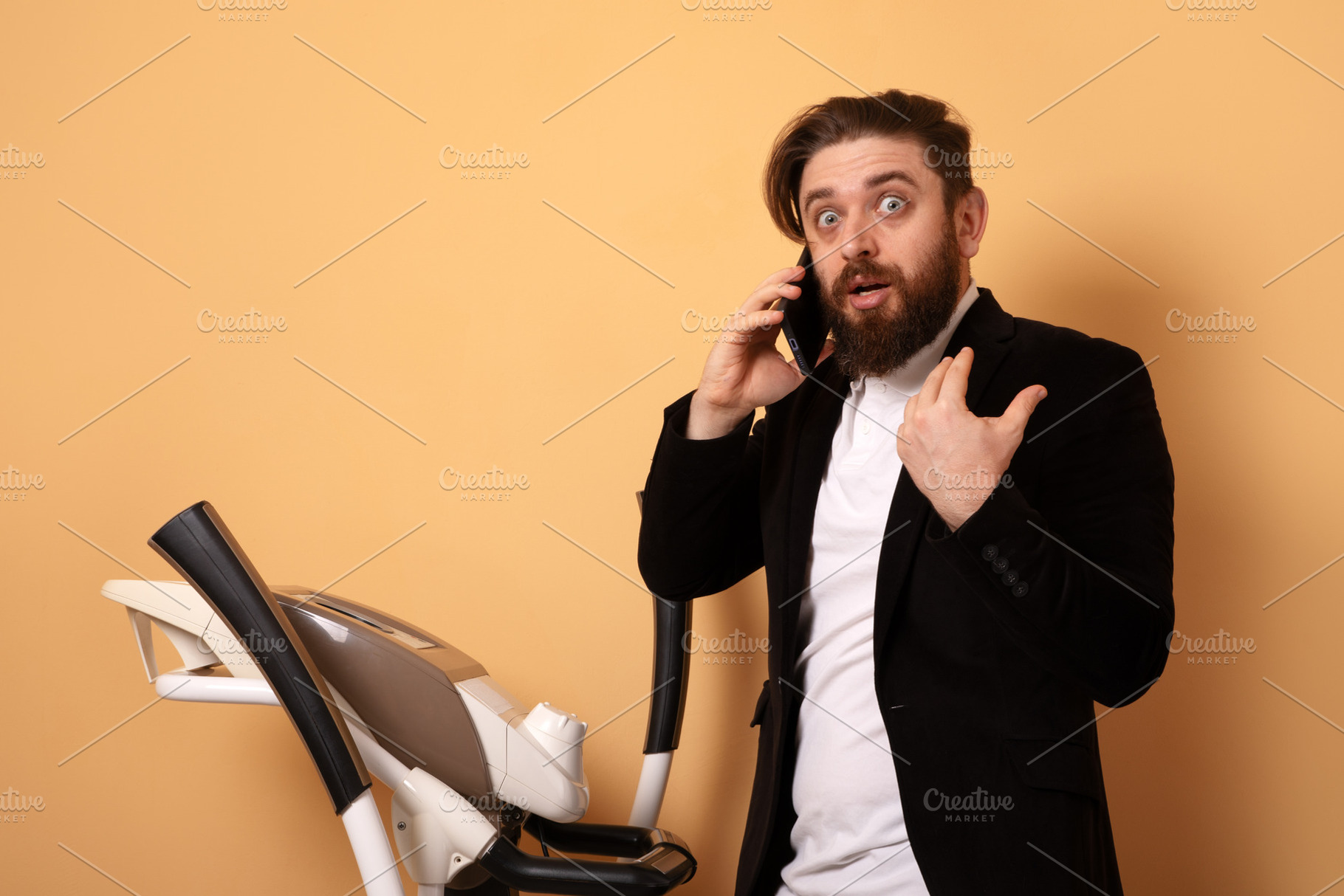 Surprised businessman in suit talking on smartphone next to trea, a Person Photo by Ales Munt
