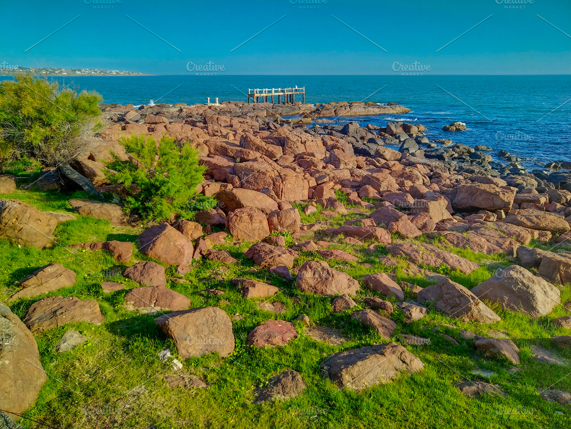 Rugged and rocky coastline on a clear day, a Nature Photo by DanFLCreativo