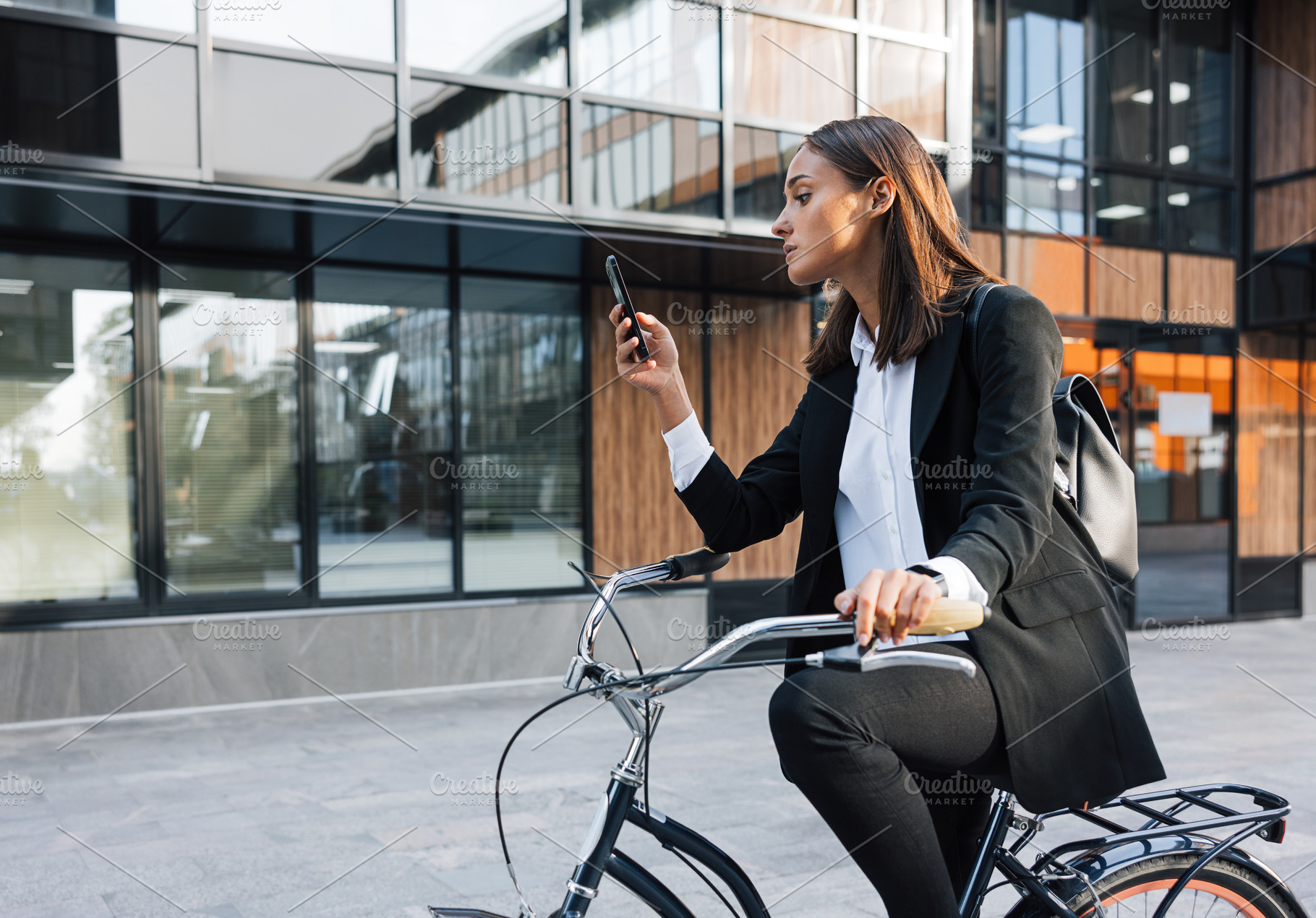 Businesswoman sitting on bicycle, a Business Photo by Artem Varnitsin