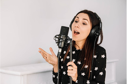 Beautiful woman in headphones sings