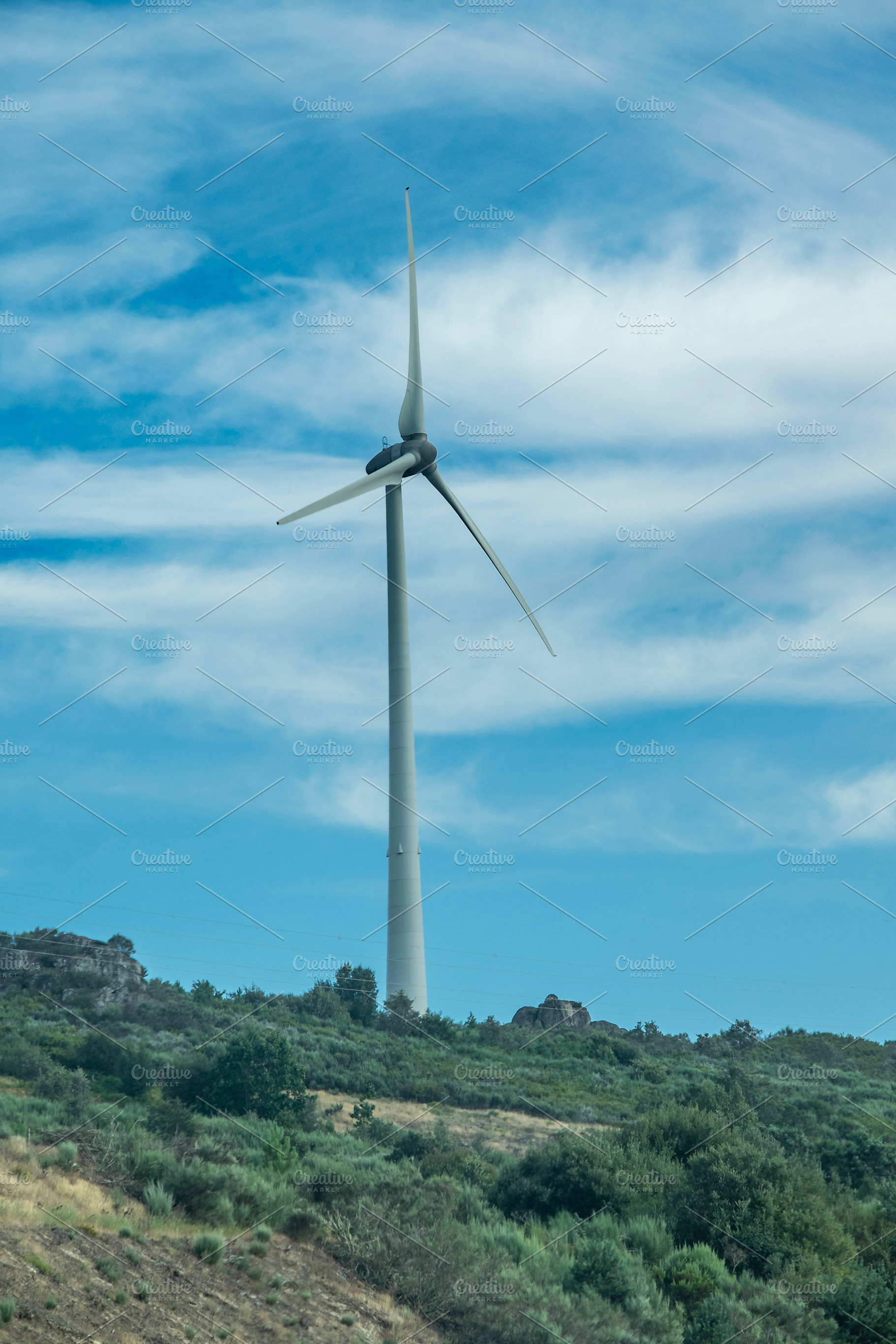 Wind turbine under cloudy sky, an Industrial Photo by DanFLCreativo