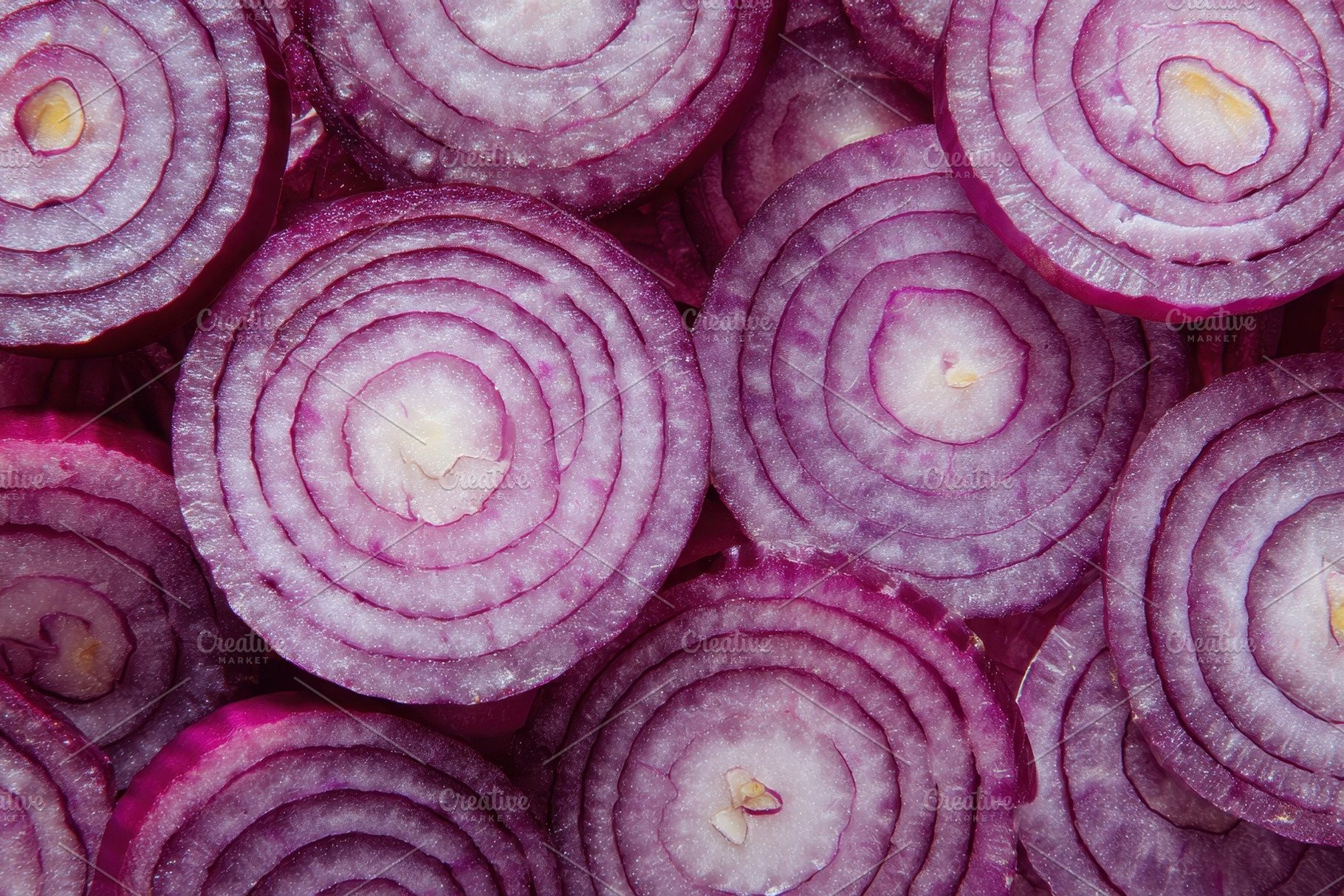 Red onion slices form circles, a Photo by Pavel_design
