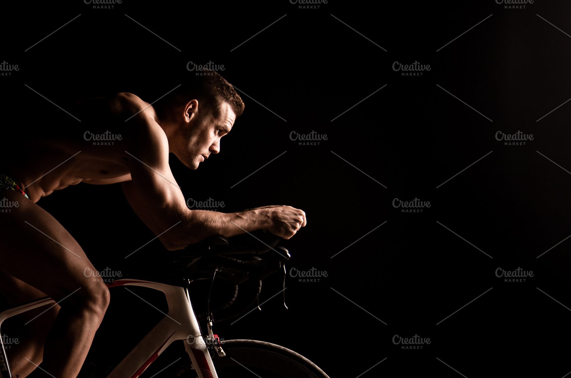 Man on bicycle preparing for triathl, a Background Photo by robcar