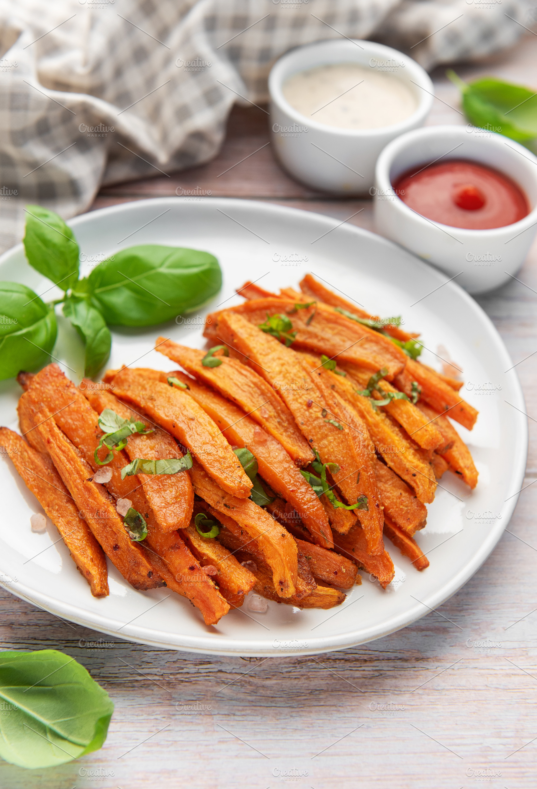 Sweet potato fries on white plate with sauces, a Food & Drink Photo by Olena Rudo