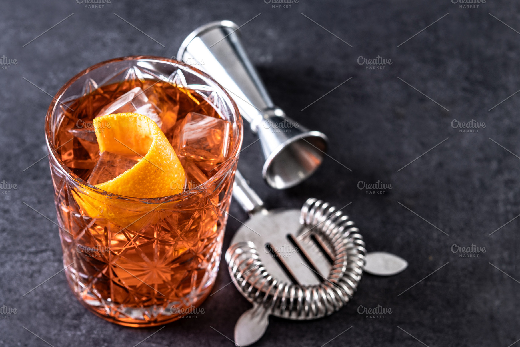Americano cocktail garnished with twist orange on black slate background, a Food & Drink Photo by etorres69
