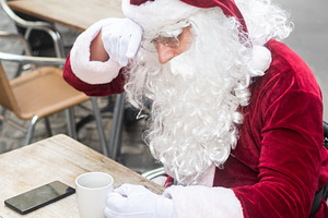 Tired Santa Claus resting at cafe with coffee, a Person Photo by etorres69