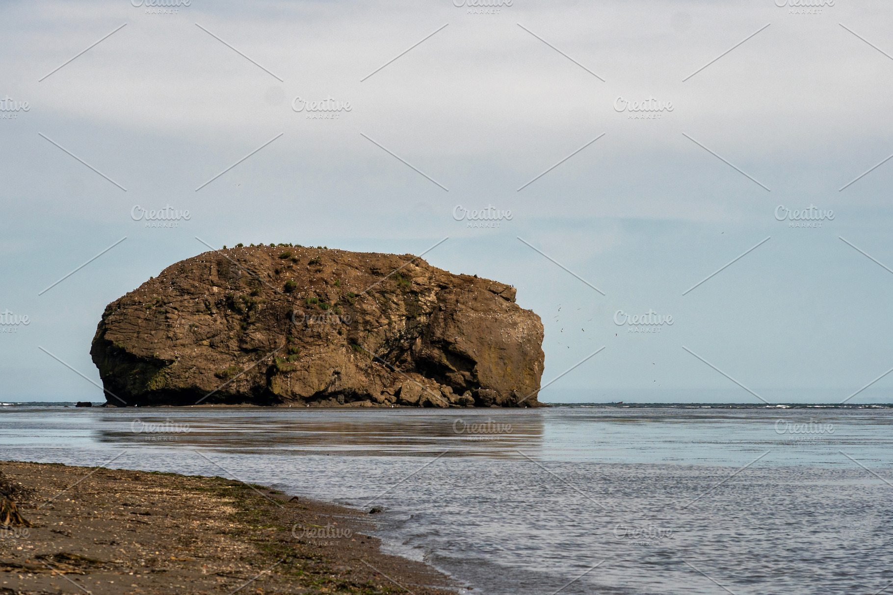 Towering rocky island rising above, a Nature Photo by Elena Vagengeim