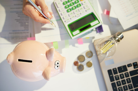 piggy bank and accountant woman with calculator and documents, a Business Photo by Alliance Images