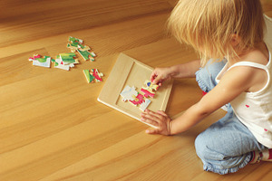 Child solving puzzle, a Person Photo by BOOCYS