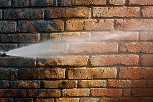 Pressure washing a brick wall, a Photo by Pavel_design