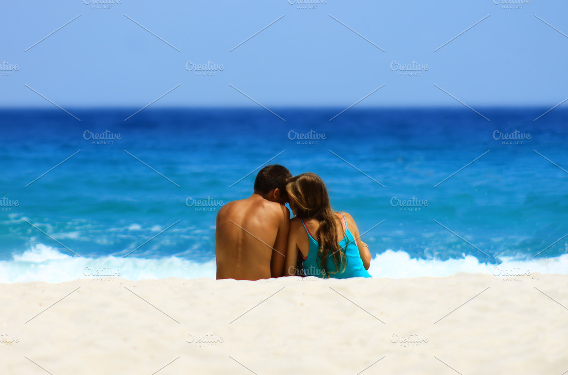Couple on the beach stock photo containing couple and boy, a Holiday Photo by VIBE Collective