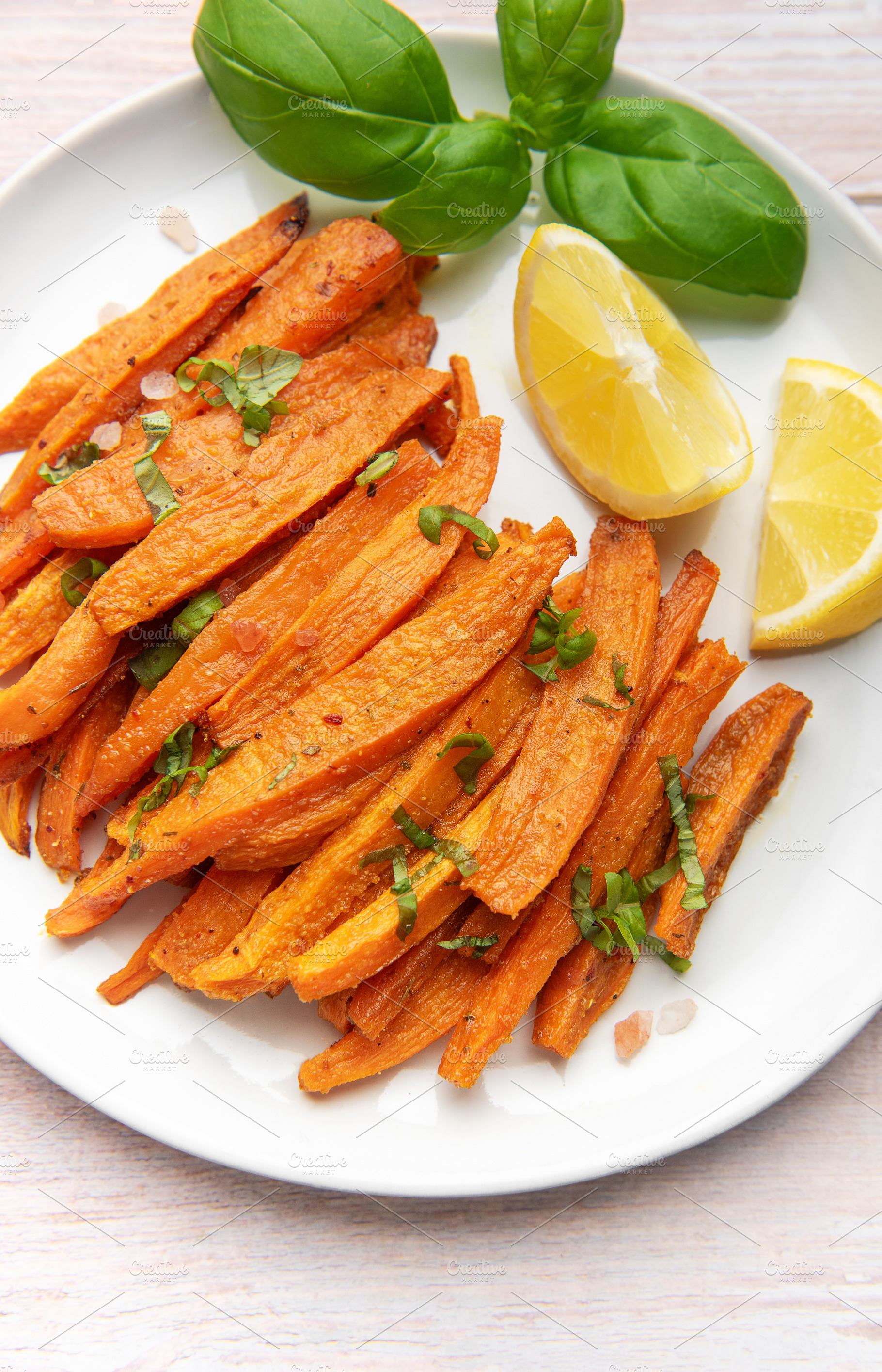 Sweet potato fries with fresh basil and lemon, a Food & Drink Photo by Olena Rudo