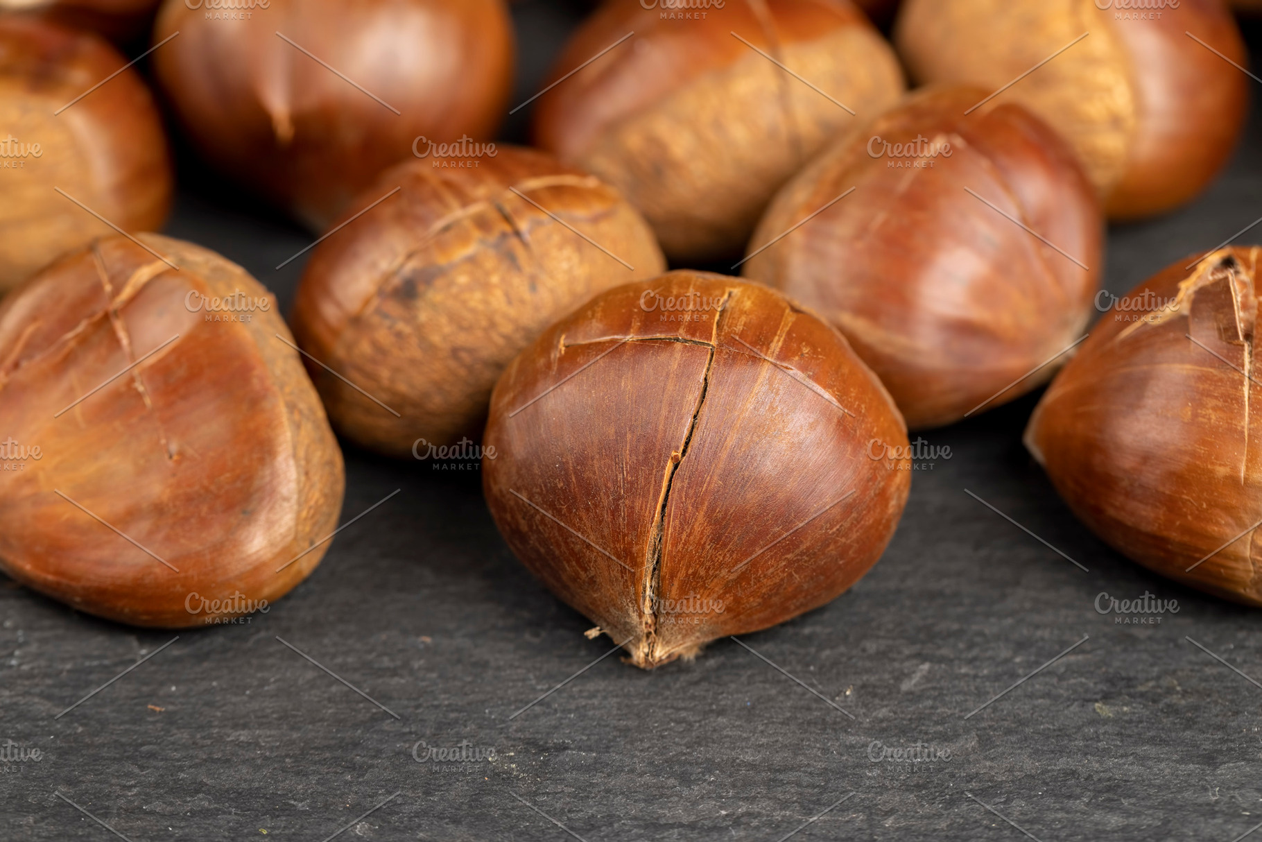 a cross incised on a chestnut shell edible Asian chestnut fruits for frying or, a Photo by rsoollAI