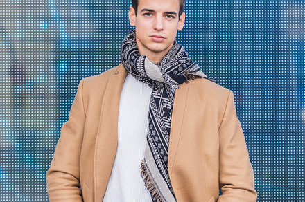 Portrait of stylish handsome young man with coat standing outdoo, a Person Photo by RF Images