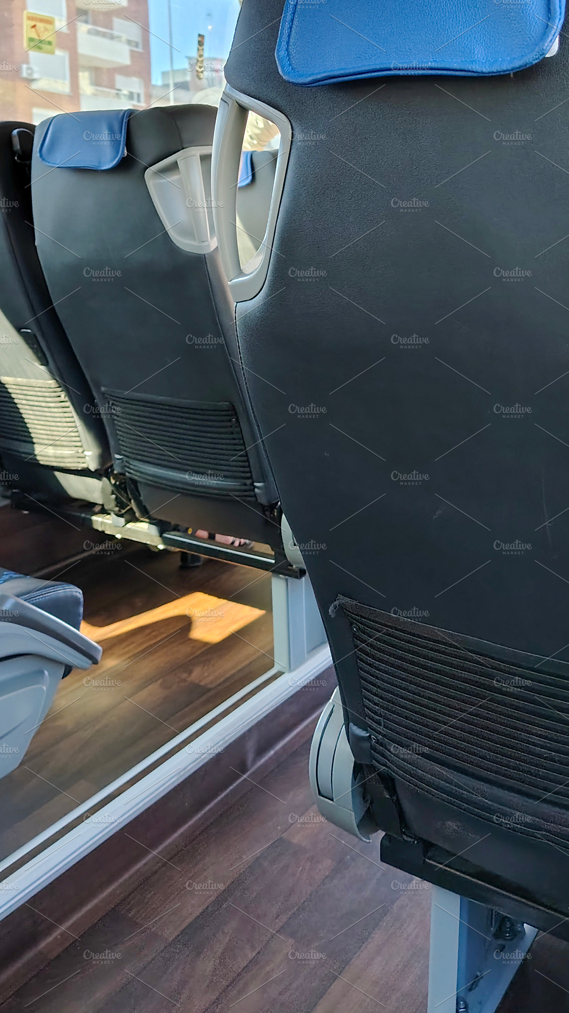 Side view of clean modern bus seats, a Transportation Photo by DanFLCreativo