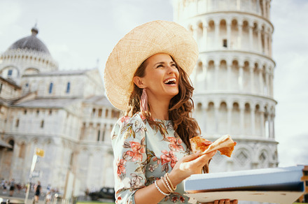 smiling trendy woman in floral dress with pizza and hat, a Person Photo by Alliance Images