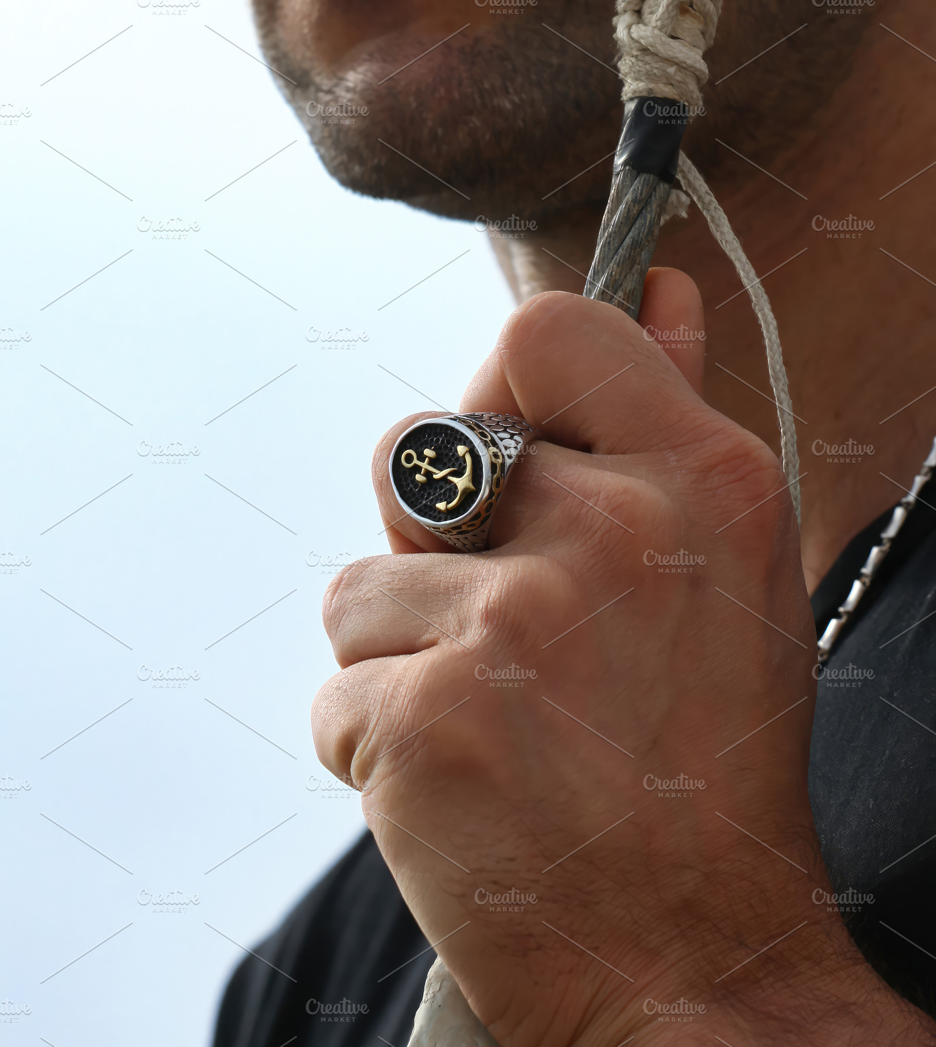 Sailor showing a maritime ring with an anchor and a rope, an Abstract Photo by Antonio Gravante Market
