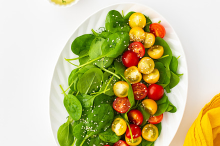 Salad with tomatoes and spinach, a Food & Drink Photo by Pandateam