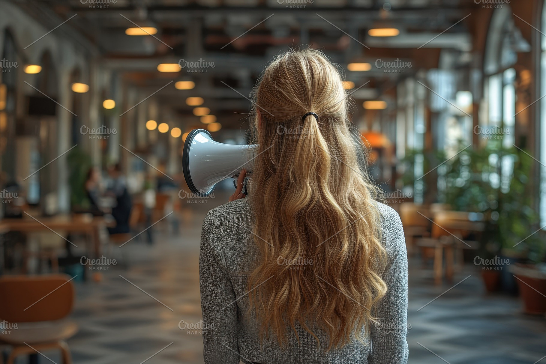 Woman with long hair holding a megap, a Photo by Tanuart