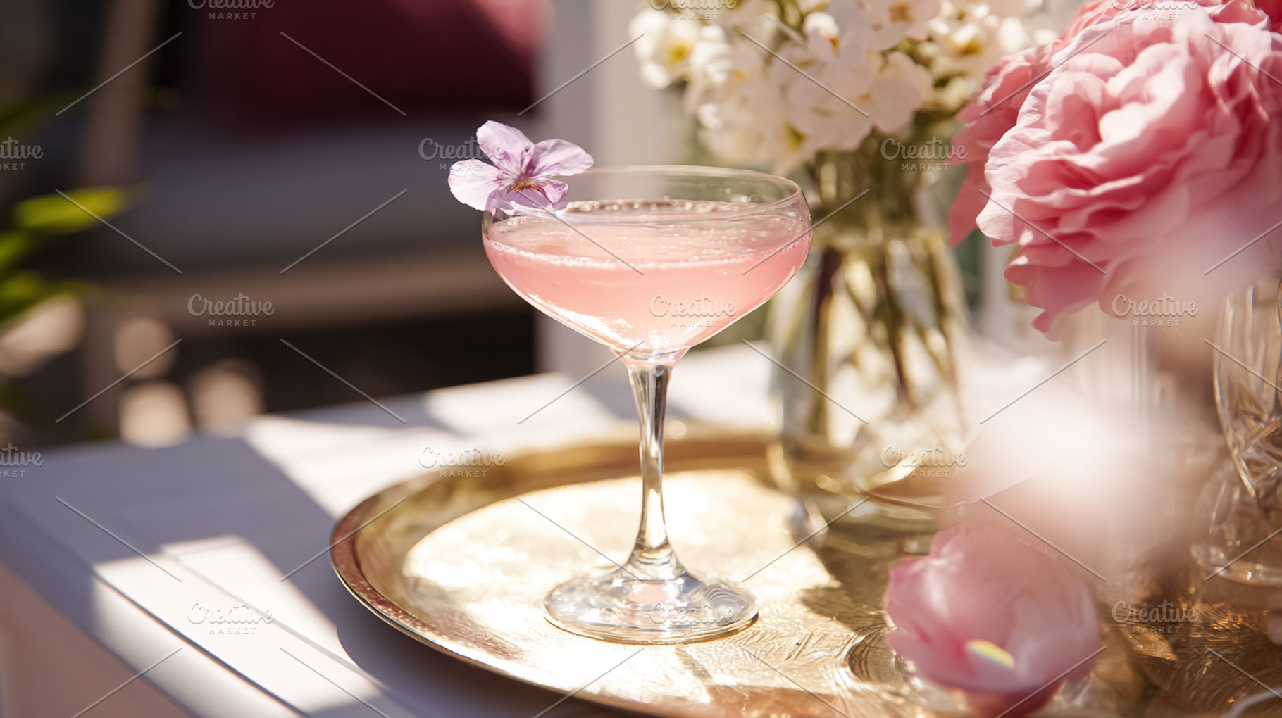 Pink cocktail glass with a floral garnish on a golden tray, cele, a Photo by Studio ANNA