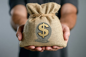 Male hands holding burlap bag with dollar symbol and banknotes on grey backgrou, a Business Photo by AlyaAnd