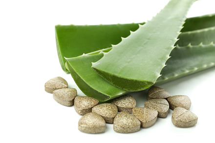 Concept of herb pills with aloe isolated on white background, a Beauty & Fashion Photo by AtlasStudio PRO