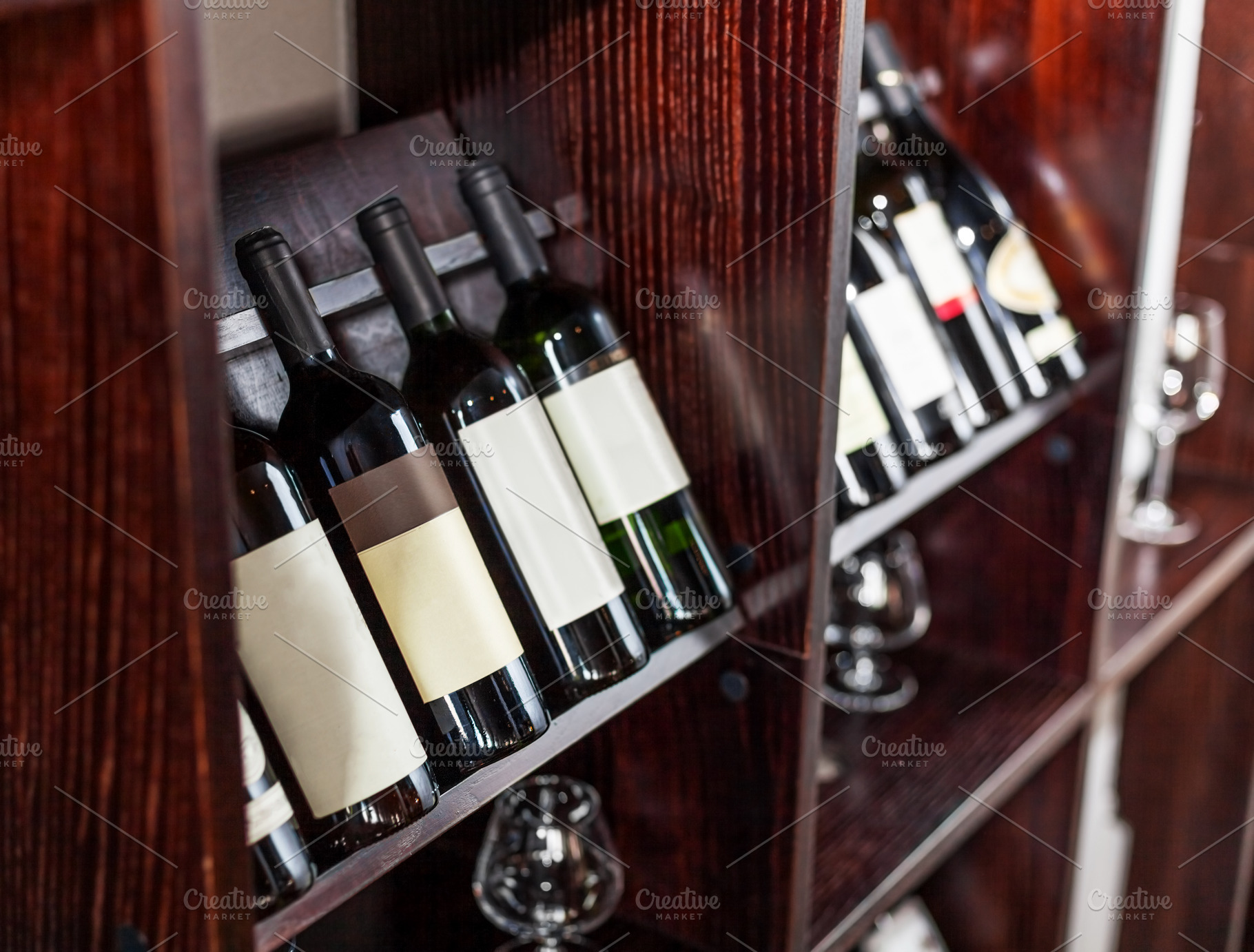 Bottles of wine displayed on the win, a Food & Drink Photo by Volff